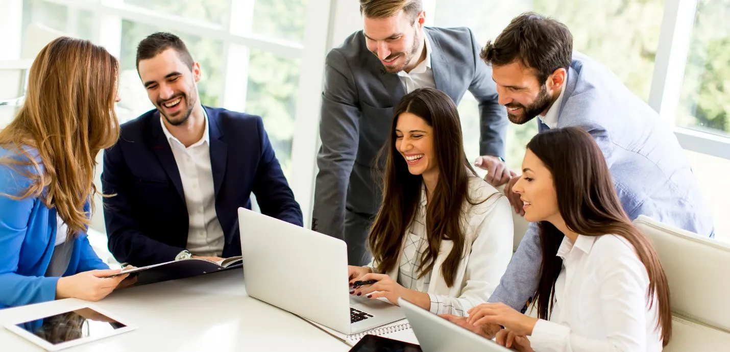 colleagues at work using a laptop