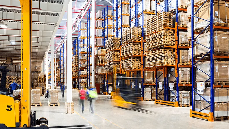Forklifts and people in warehouse