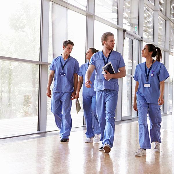 Healthcare staff walking in hospital corridor